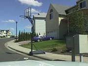 Basketball hoop obstructing the sidewalk