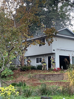 Firefighters around a house